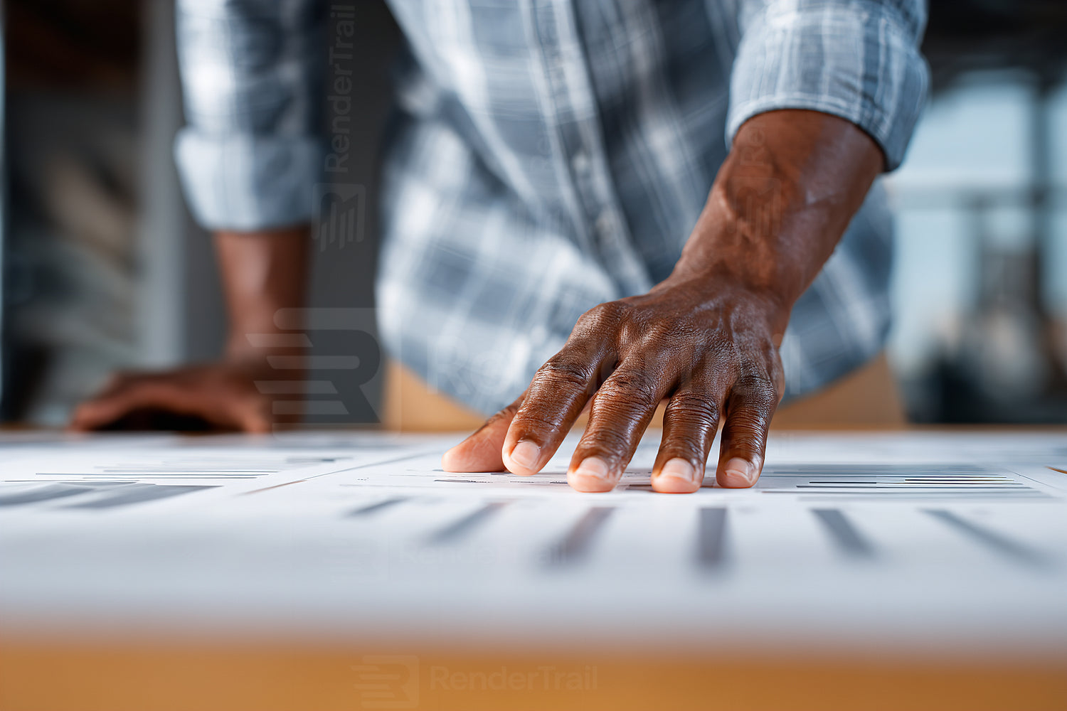 Touching detailed plans for a project in a bright workspace during the day